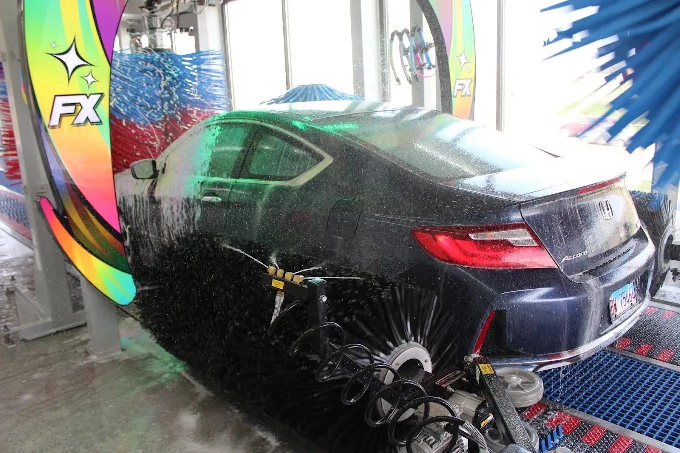 A car getting the colorful FX foam treatment in the tunnel